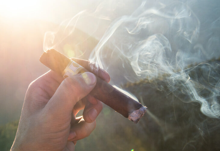 Cigar Being Smoked and Canoeing
